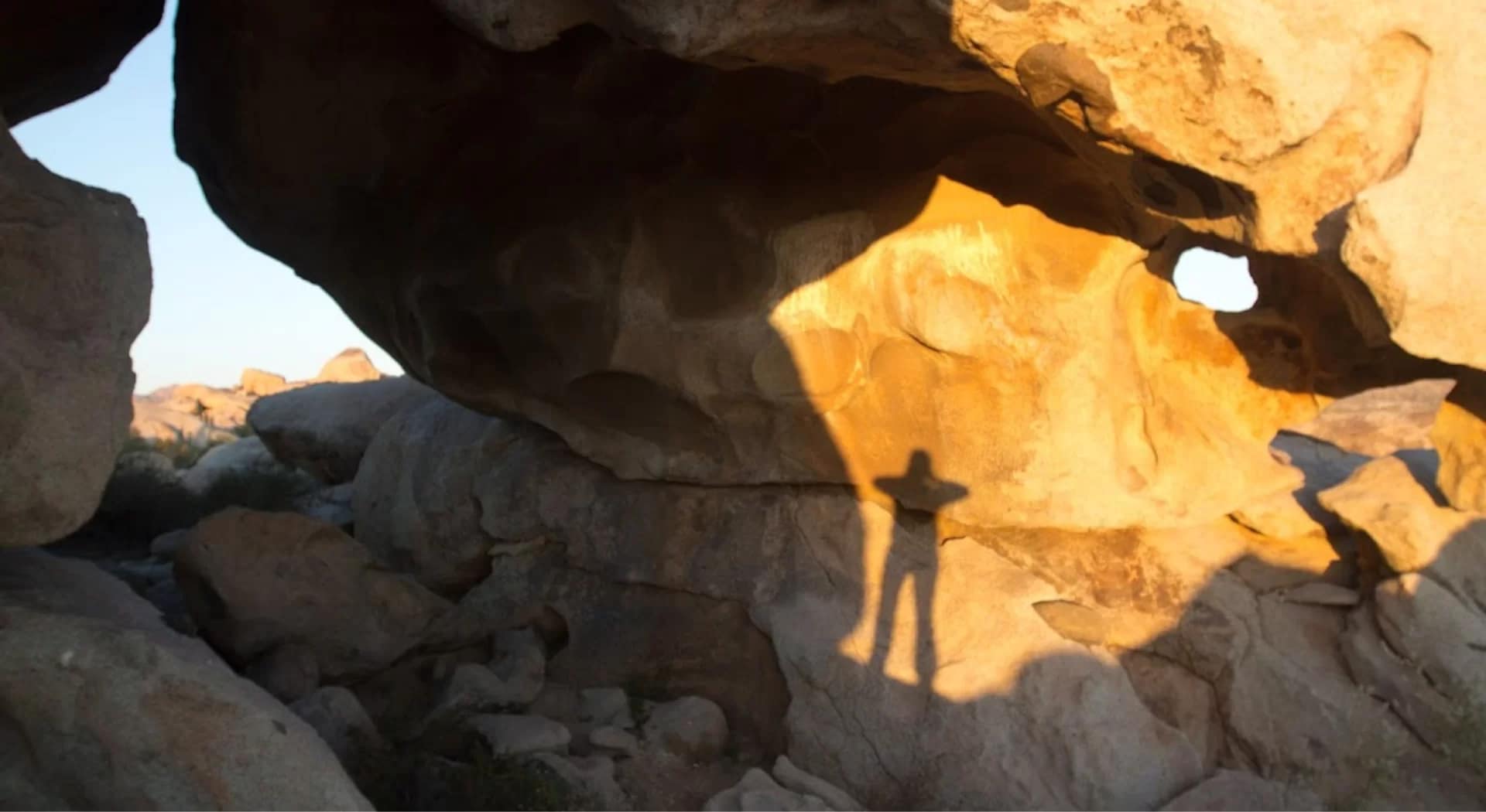 a shadow among boulders